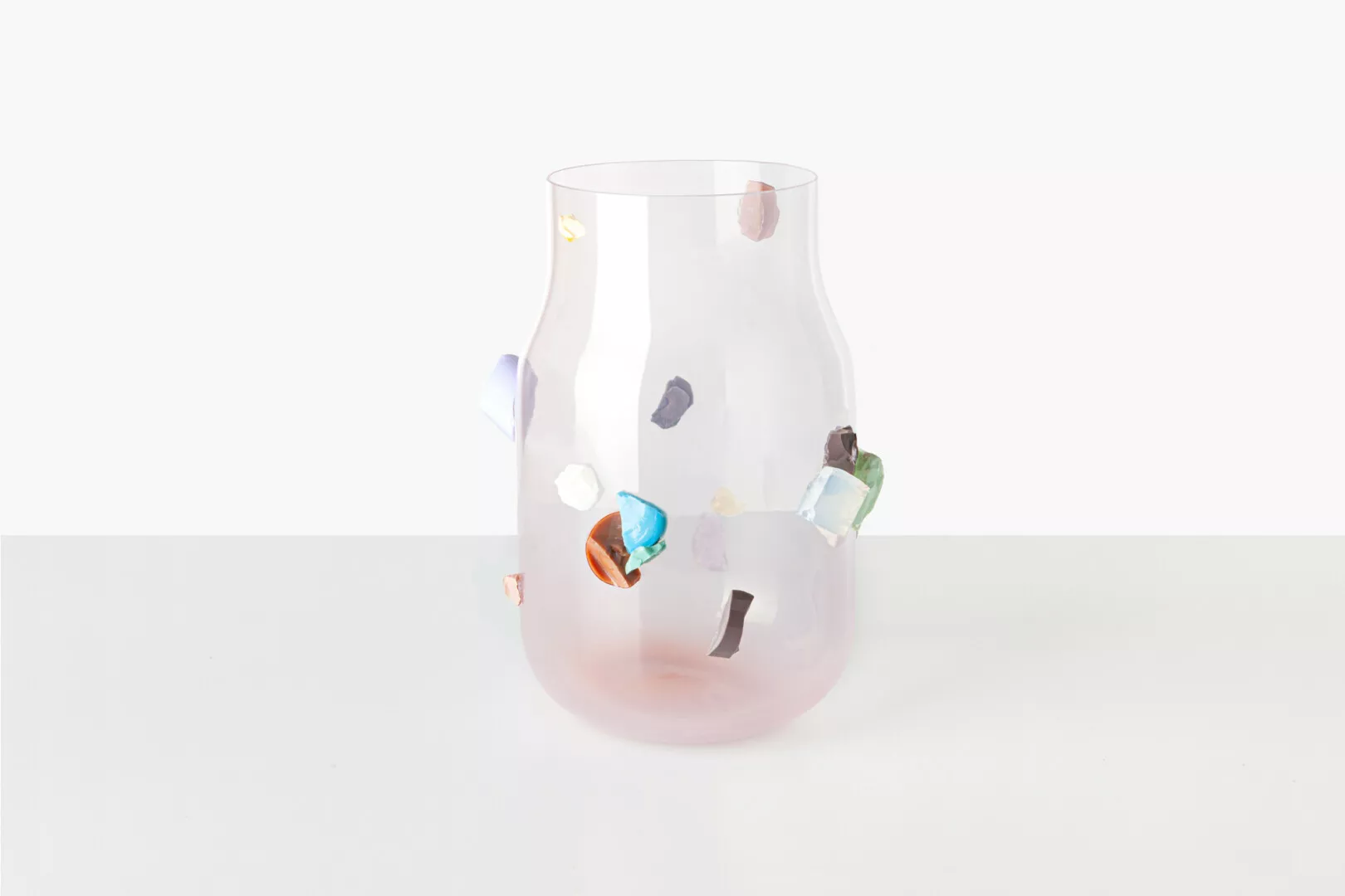 Clear glass vase with colorful embedded stones.