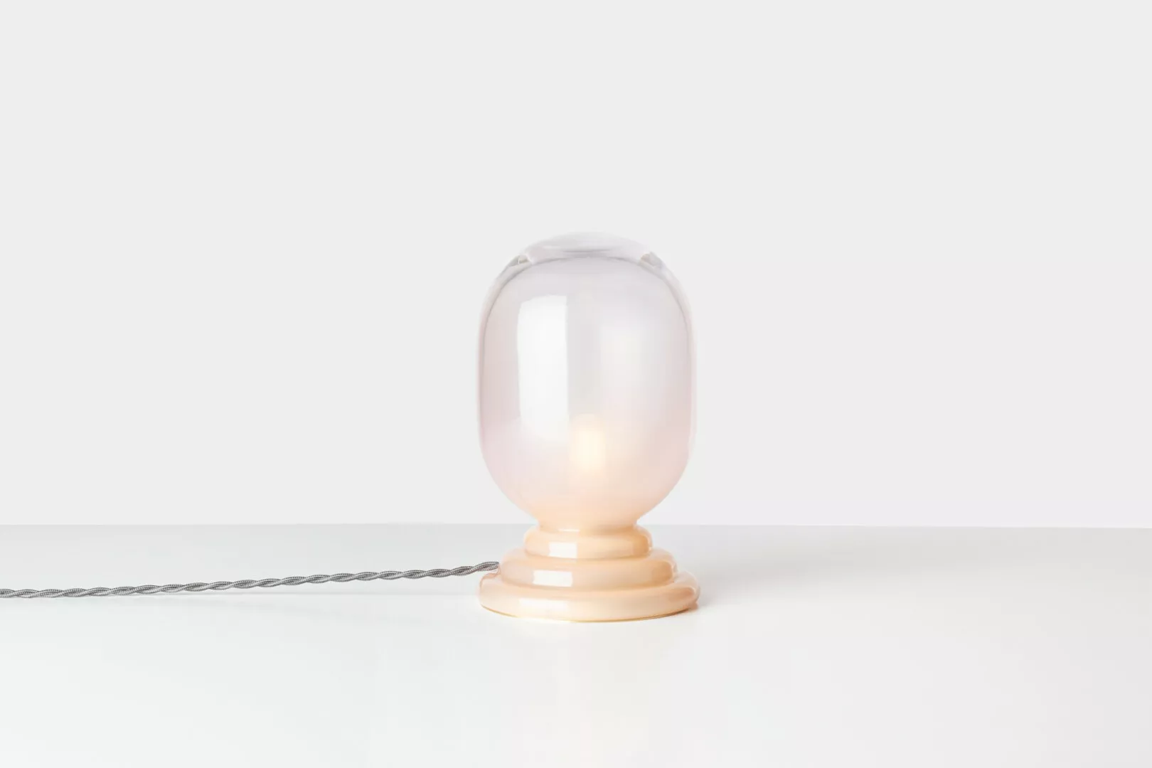 Minimalist glass lamp on white background